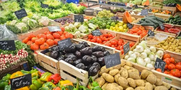 Colorful vegetables arranged in wooden market crates