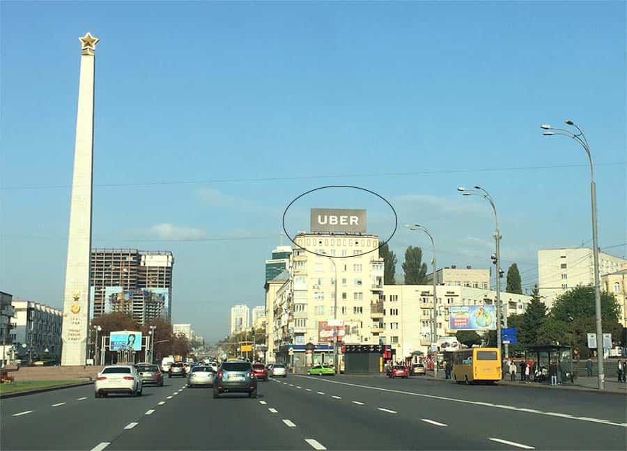 Large Uber advertisement above a central Kyiv street in 2017